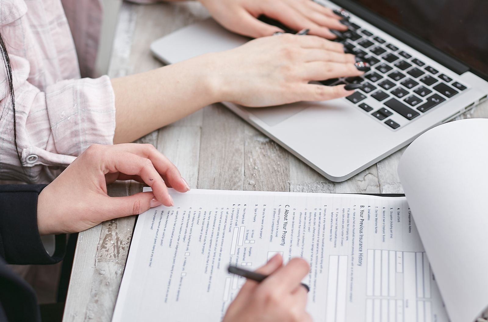 Reviewing official exam forms and policies at a desk, the ground the candidate handbook covers