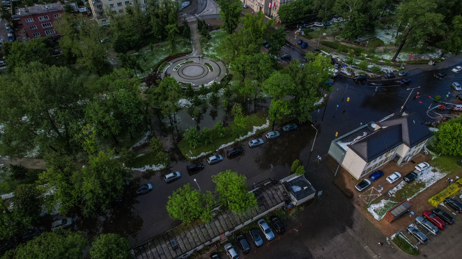 Aerial view of a flooded city park after a storm, the natural-hazard exposure a LEED v5 Climate Resilience Assessment examines