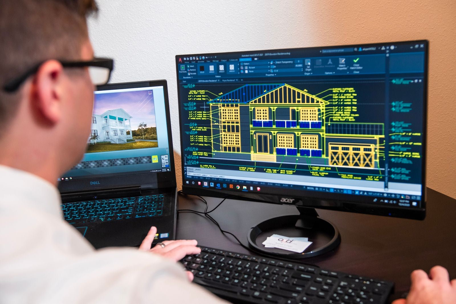Engineer analyzing a detailed building model with performance data on screen, the work of building energy modeling