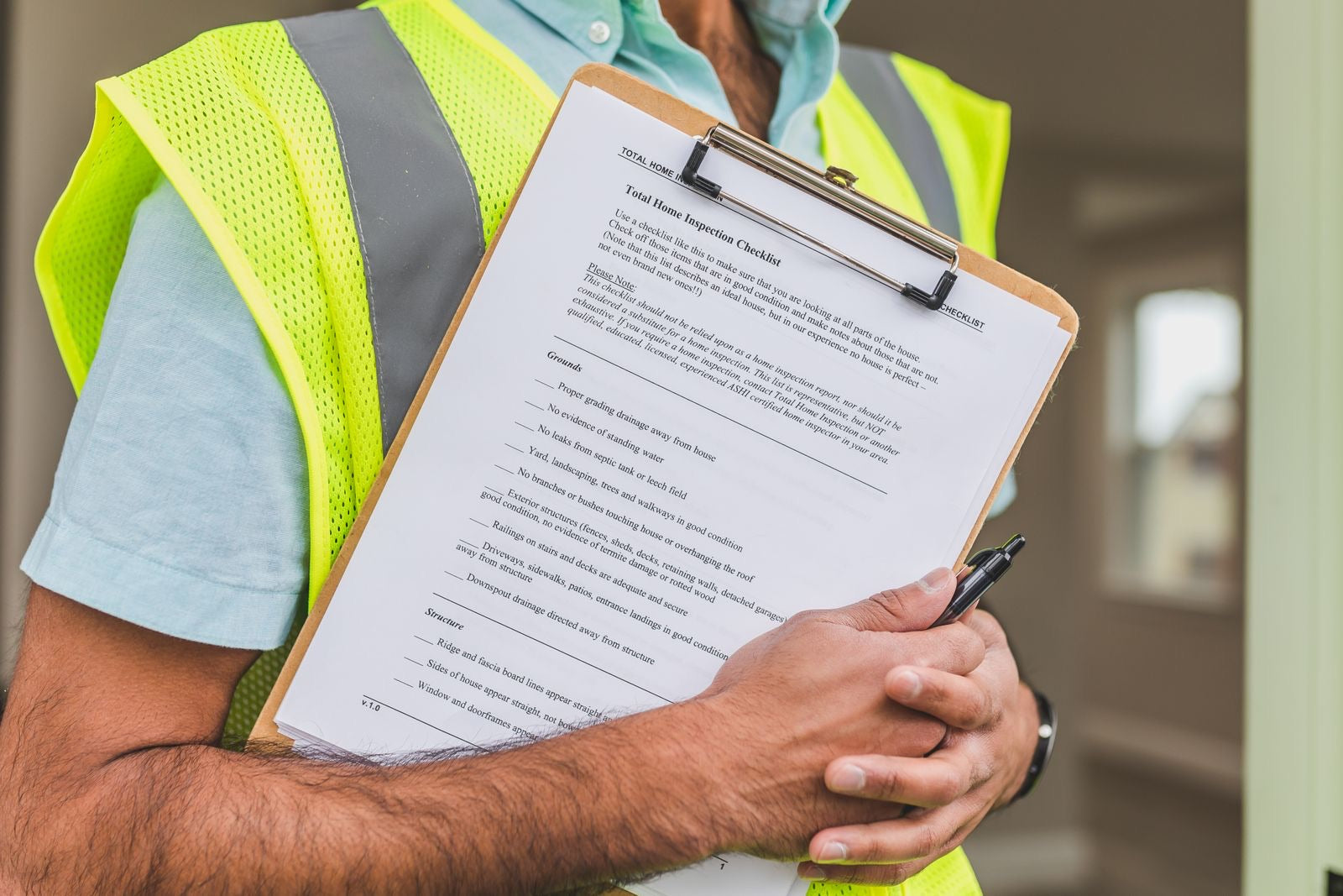 Building inspector holding a checklist, the requirements a LEED project must satisfy