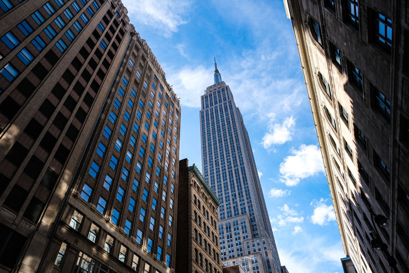The Empire State Building against a blue sky, the most famous LEED certified retrofit