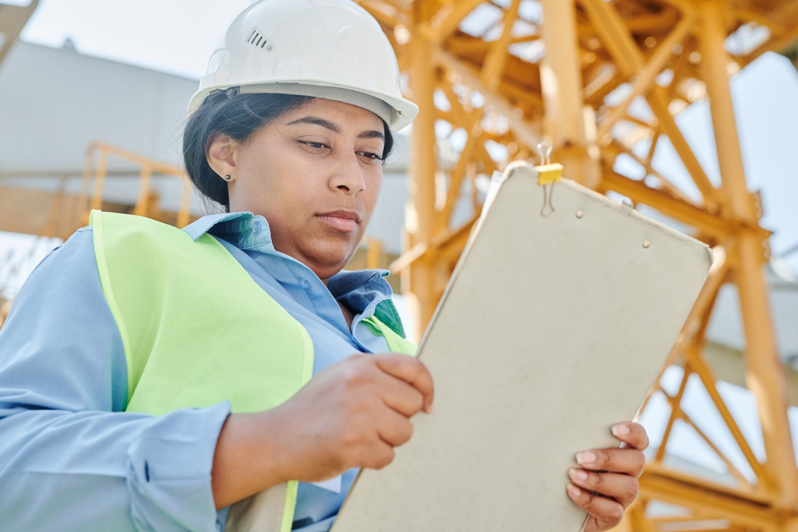 Engineer reviewing a LEED scorecard checklist on a construction site